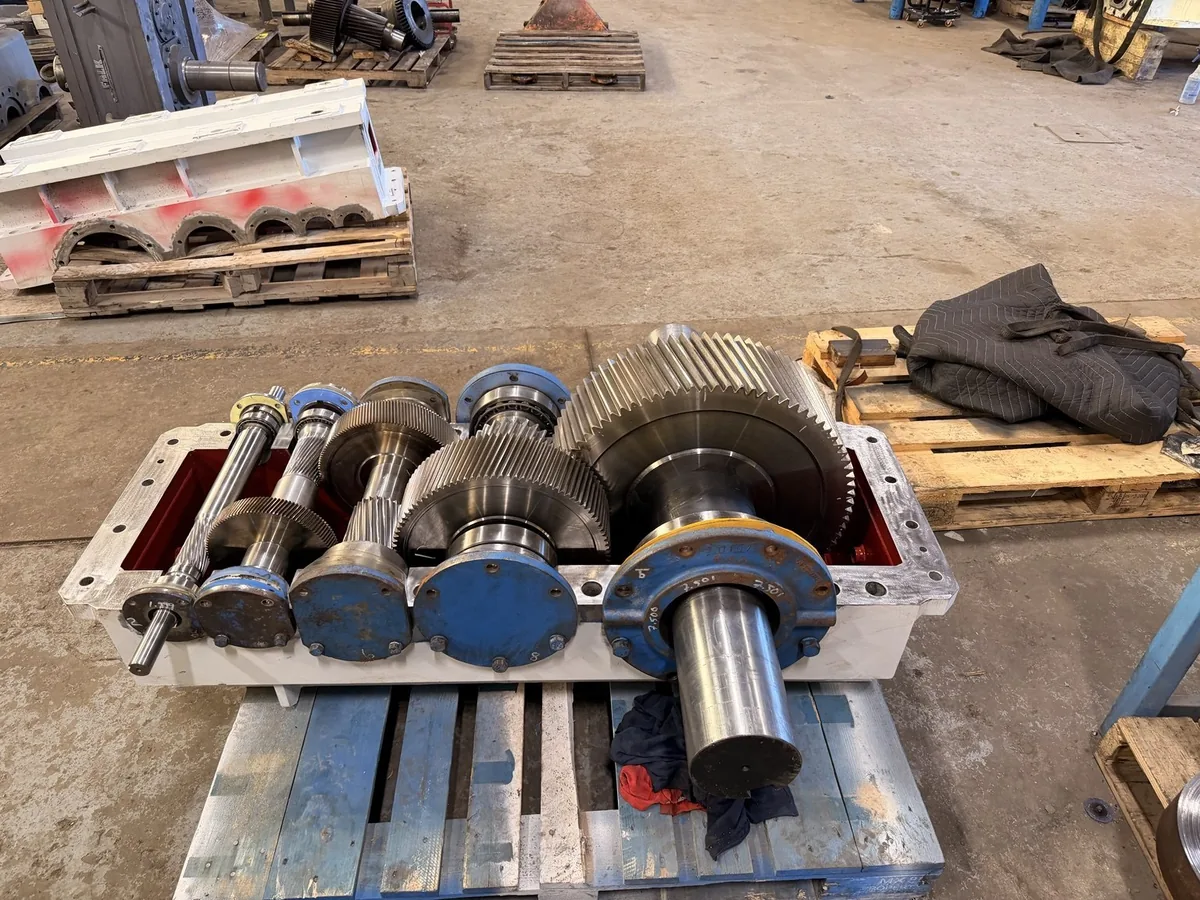 Multiple gears, shafts and bearings installed in the lower housing before closure.